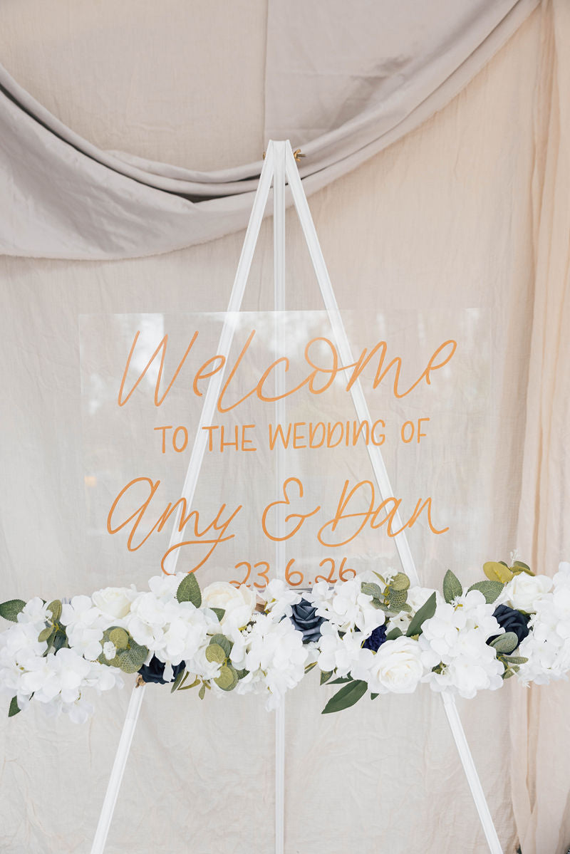 Wedding welcome sign with floral decorations on a neutral background